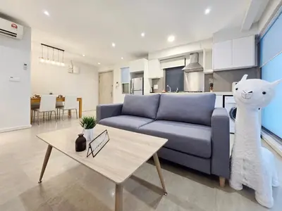 a living room with a blue couch and a table at Kuala Lumpur Bintang Fairlane #107 TRX Pavilion KL in Kuala Lumpur