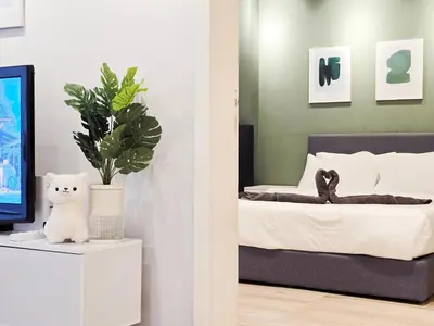 a bedroom with a bed with a plant and a tv at Kuala Lumpur Bintang Fairlane #107 TRX Pavilion KL in Kuala Lumpur