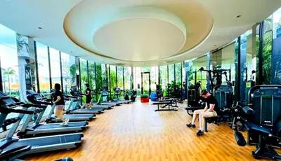 a gym with people exercising on tread machines in a building at Trion Homestay -KL in Kuala Lumpur