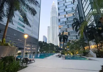 a pool in the middle of a city with tall buildings at MARC Residence KLCC by VastHaven in Kuala Lumpur