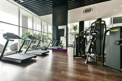 a gym with several treadmills and elliptical machines at KLCC Quill Residences by Avery #Located in the City Center #10 mins walk to Twin Towers #Infinity pool#\u4e2d\u82f1\u6587\u623f\u4e1c in Kuala Lumpur