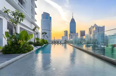 a swimming pool on the roof of a building with a city skyline at KLCC Quill Residences by Avery #Located in the City Center #10 mins walk to Twin Towers #Infinity pool#\u4e2d\u82f1\u6587\u623f\u4e1c in Kuala Lumpur