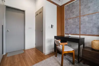 a room with a desk and a chair and a door at Ancestry 3BR M Vertica MRT Access by RumaBnB in Kuala Lumpur