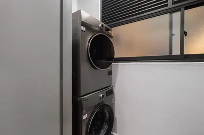 a washer and dryer in a kitchen at Ancestry 3BR M Vertica MRT Access by RumaBnB in Kuala Lumpur