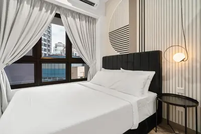 a bedroom with a white bed and a window at Prestige 2BR Agile BB WiFi Netflix in Kuala Lumpur