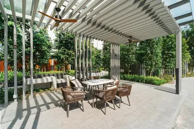 a patio with a table and chairs under a pergola at Prestige 2BR Agile BB WiFi Netflix in Kuala Lumpur