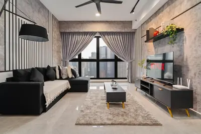 a living room with a black couch and a tv at Prestige 2BR Agile BB WiFi Netflix in Kuala Lumpur