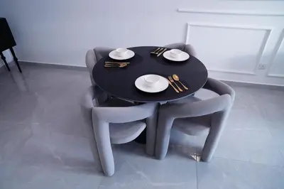 a black table and chairs with plates and bowls on it at Agile Residence Bukit Bintang by Luma in Kuala Lumpur