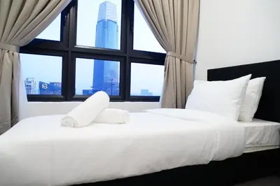 a bedroom with a white bed with a large window at Agile Residence Bukit Bintang by Luma in Kuala Lumpur