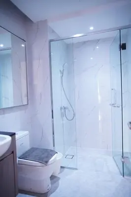 a bathroom with a glass shower and a toilet at Agile Residence Bukit Bintang by Luma in Kuala Lumpur