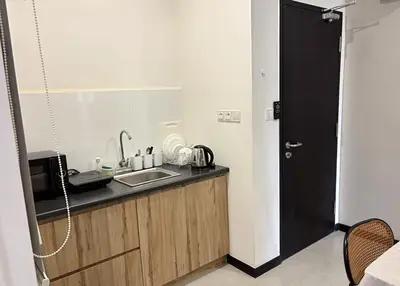 a small kitchen with a sink and a microwave at Neu Suites Apartments by LammyNora in Kuala Lumpur