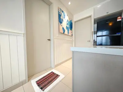 a kitchen with white cabinets and a counter top at TRION The 108 Family Suite Pool & City view in Kuala Lumpur