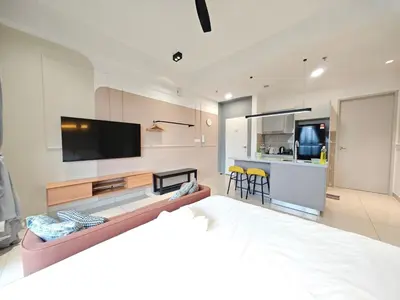 a living room with a large bed and a television at TRION POOL & KL City View The 110 Family Suite in Kuala Lumpur