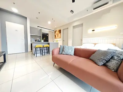 a living room with a couch and a kitchen at TRION POOL & KL City View The 110 Family Suite in Kuala Lumpur