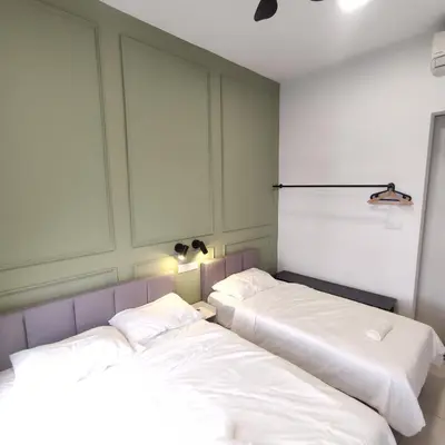 two beds sitting next to each other in a room at TRION The 101 Family Suite Pool & KL City View in Kuala Lumpur
