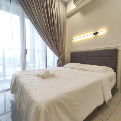 a bedroom with a bed with a towel on it at TRION The 101 Family Suite Pool & KL City View in Kuala Lumpur