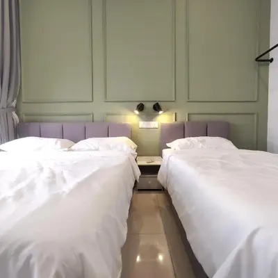 two beds sitting next to each other in a room at TRION The 101 Family Suite Pool & KL City View in Kuala Lumpur
