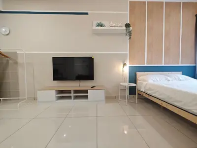 a bedroom with a bed and a flat screen tv at TRION 2BR 6pax Ikea BBCC TRX Velocity KL Base 3KM in Kuala Lumpur