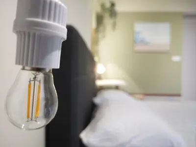 a light bulb in a bedroom with a bed at TRION 2BR 6pax Ikea BBCC TRX Velocity KL Base 3KM in Kuala Lumpur