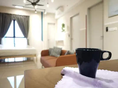 a coffee cup sitting on a table in a living room at TRION 2BR 6pax Ikea BBCC TRX Velocity KL Base 3KM in Kuala Lumpur