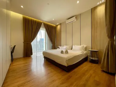 a bedroom with a bed and a large window at Quill Comport Suits KLCC in Kuala Lumpur