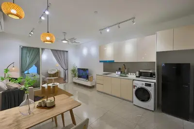 a kitchen and living room with a table and a stove at Quill Comport Suits KLCC in Kuala Lumpur