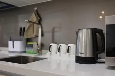 a coffeemaker sitting on a kitchen counter next to a sink at Quill Comport Suits KLCC in Kuala Lumpur