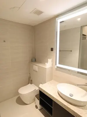 a bathroom with a toilet and a sink and a mirror at Star Residance KLCC by Nexus 84 in Kuala Lumpur