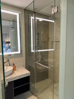 a glass shower in a bathroom with a sink at Star Residance KLCC by Nexus 84 in Kuala Lumpur