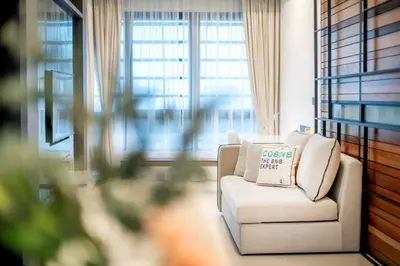 a white chair in a room with a window at NOVO Ampang Stylish Studio & 1BR with Infinity Pool near KLCC & Gleneagles in Kuala Lumpur