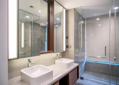 a bathroom with two sinks and a glass shower at NOVO Ampang Stylish Studio & 1BR with Infinity Pool near KLCC & Gleneagles in Kuala Lumpur