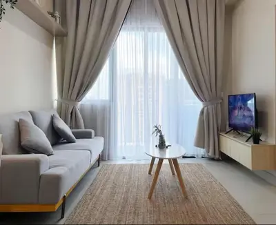 a living room with a couch and a table at The Colony By Infinitum P in Kuala Lumpur