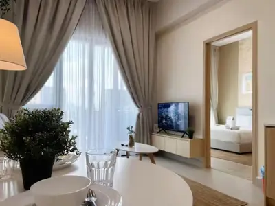 a living room with a table and a large window at The Colony By Infinitum P in Kuala Lumpur