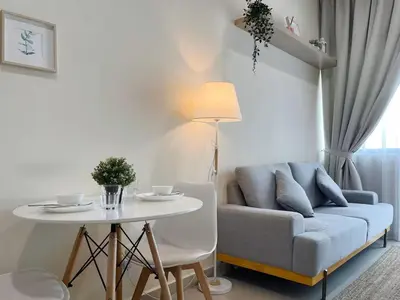 a living room with a blue couch and a table at The Colony By Infinitum P in Kuala Lumpur