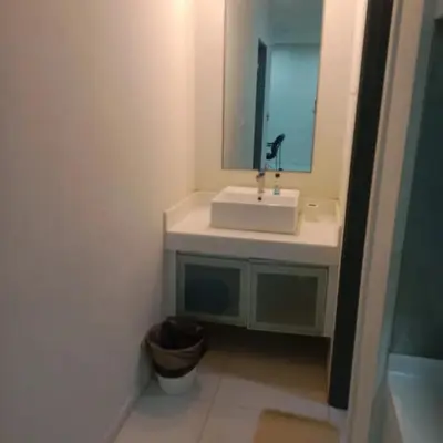 a bathroom with a white sink and a mirror at summer suites studios in Kuala Lumpur