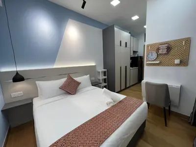 a bedroom with a bed and a table and a chair at THE COLONY BY INFINITUM by ZENTRIP in Kuala Lumpur