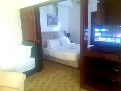 a hotel room with a bed and a television at Happy holiday suites at times square KL in Kuala Lumpur