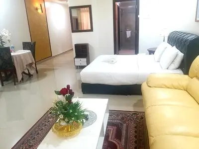 a hotel room with a bed and a couch at Happy holiday suites at times square KL in Kuala Lumpur