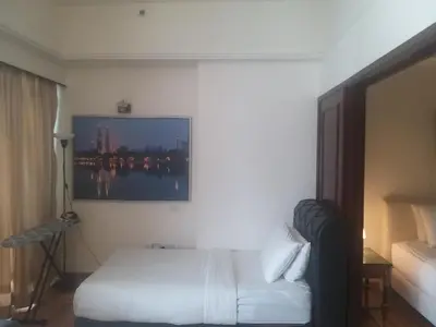a hotel room with a bed and a tv on the wall at Happy holiday suites at times square KL in Kuala Lumpur