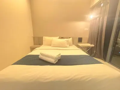 a bedroom with a bed with white sheets and pillows at Summer popular suites kl Bukit Bintang in Kuala Lumpur