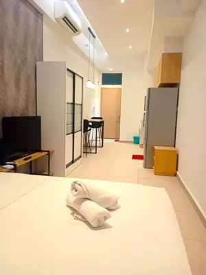 a living room with a white towel on the floor at Lucky Suites KLCC By LUXE Infinitum in Kuala Lumpur