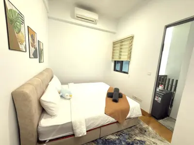 a bedroom with a bed and a couch at Lucky Suites KLCC By LUXE Infinitum in Kuala Lumpur