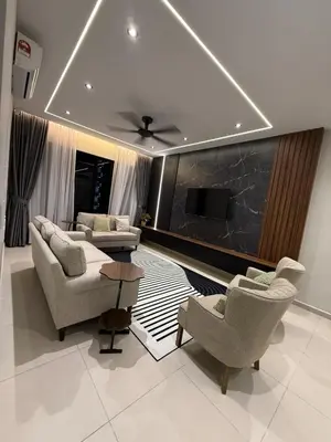 a living room with couches and a flat screen tv at Alaxis Suite Home By Residensi Brickfields in Kuala Lumpur