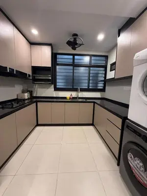 a kitchen with white cabinets and a washer and dryer at Alaxis Suite Home By Residensi Brickfields in Kuala Lumpur