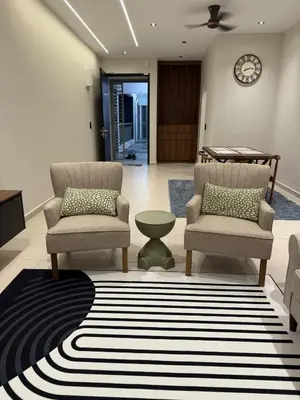 a living room with two chairs and a rug at Alaxis Suite Home By Residensi Brickfields in Kuala Lumpur