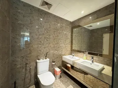 a bathroom with a toilet and a sink and a mirror at Dorsett Hartamas, KL City, Bathtub, Rooftop Pool in Kuala Lumpur