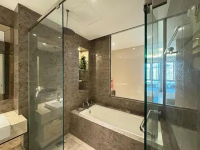 a bathroom with a tub and a glass shower at Dorsett Hartamas, KL City, Bathtub, Rooftop Pool in Kuala Lumpur