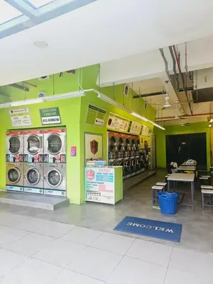 a store with washers and dryers on a green wall at Colony Infinitum KualaLumpur by FR in Kuala Lumpur