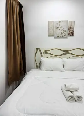 a bedroom with a bed with towels on it at Neu Suites #2BR Apartment by LammyNora in Kuala Lumpur