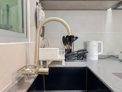 a kitchen sink with a faucet next to a counter at Mountain City View 3BR Condo with Swimming Pool & Free WiFi Netflix in Kuala Lumpur
